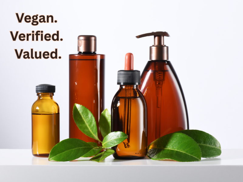 Vegan shampoo, conditioner, and serum bottles arranged with fresh leaves—perfect for promoting eco-friendly, certified clean haircare solutions.